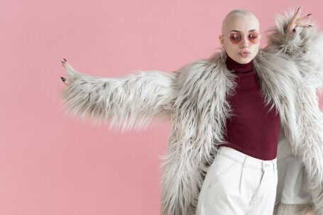 Trending Outfits - Fashionable woman in fur coat dancing in studio