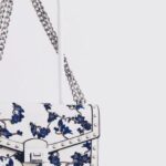 Fashion - White and Blue Floral Flap Sling Bag Hanging on White Steel Rack