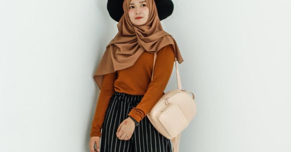Fashion - Woman in Brown Long-sleeved Shirt and Brown Hijab Headdress With Beige Leather Backpack