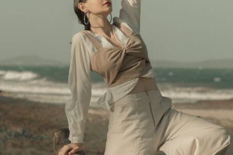 Fashion - Woman Standing Near Driftwood