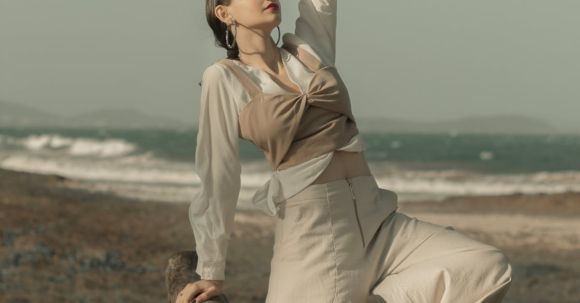Fashion - Woman Standing Near Driftwood