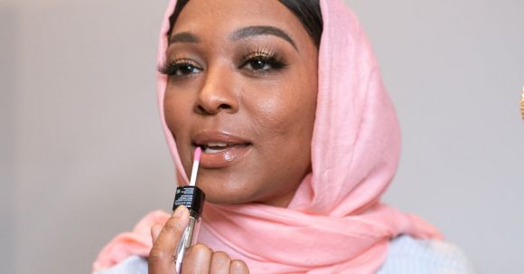 Styling - Woman in Pink Hijab Applying Lipstick