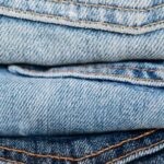 Trending Outfits - Stack of blue jeans arranged by color