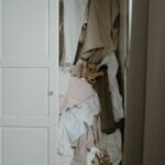 Wardrobe Essentials - Photo of an Untidy and Messy White Wooden Closet